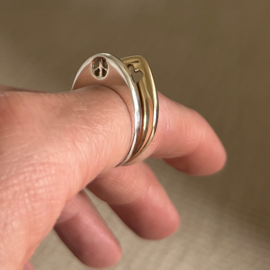 Silver Peace Slice Ring Worn Stacked on Finger with Gold Heart Slice Ring