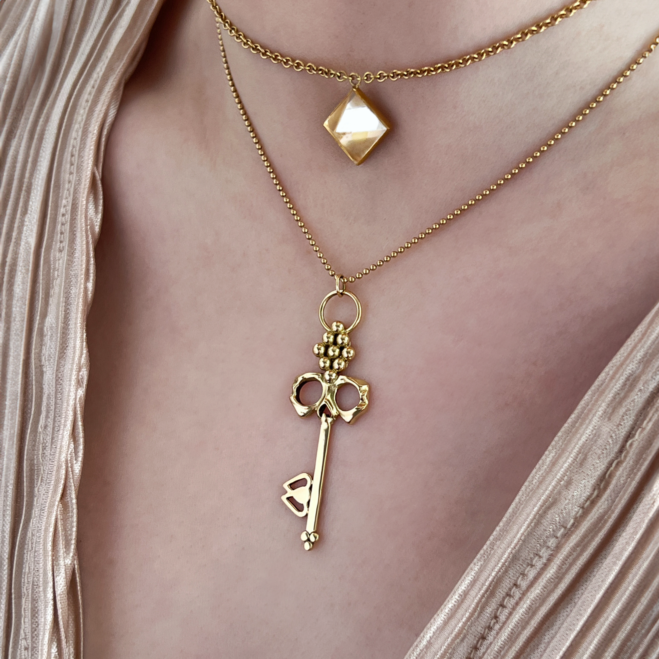 18K gold Skull Key Necklace worn on neck