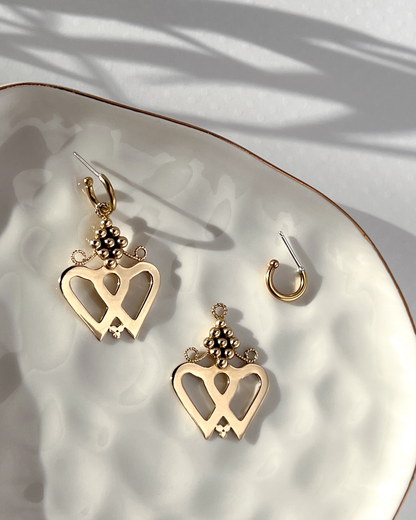 Brass Luckenbooth Earrings that hang from detachable Huggie Hoops on jewelry dish