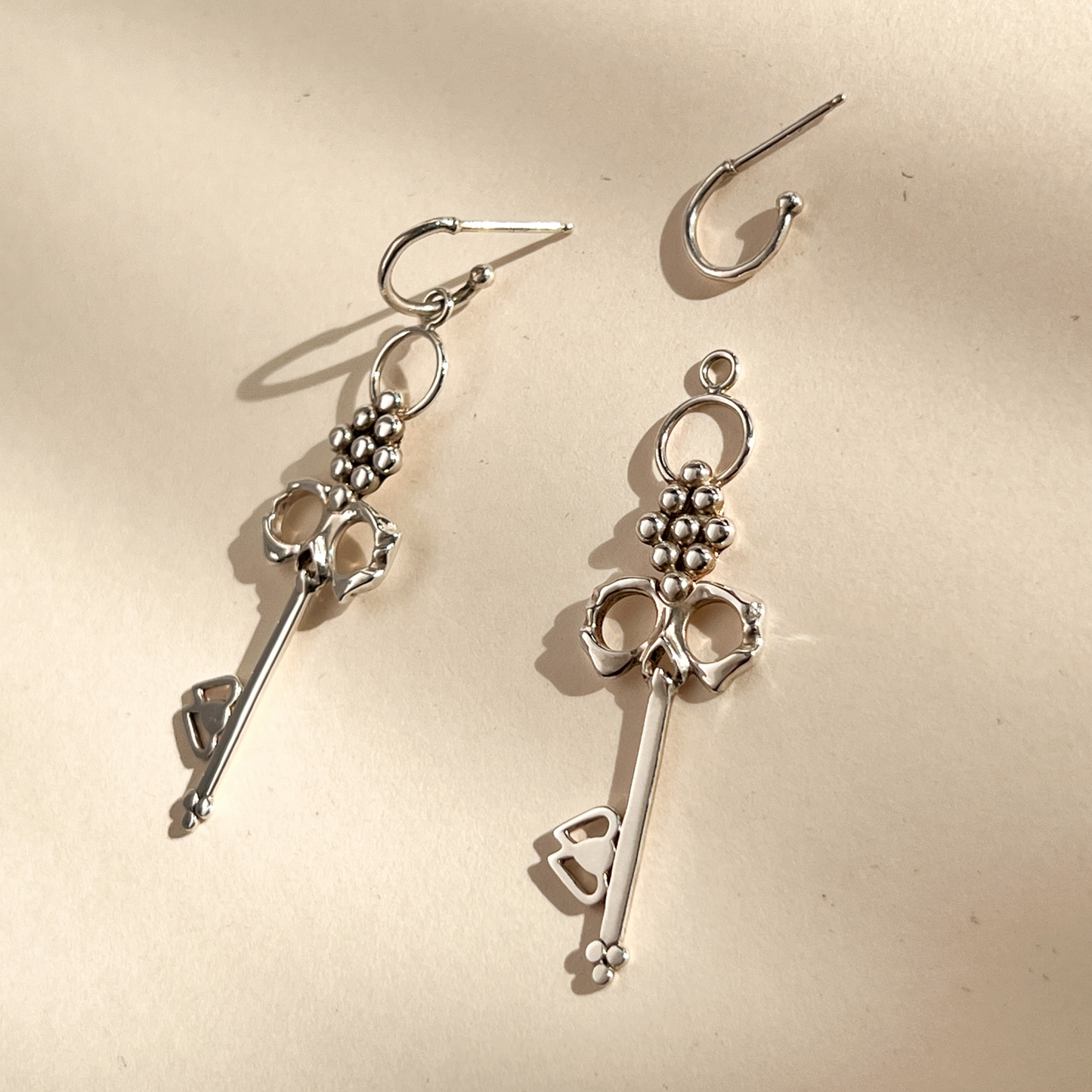 Sterling Silver Skull Key Earrings that dangle from detachable Huggie Hoops that can be worn alone