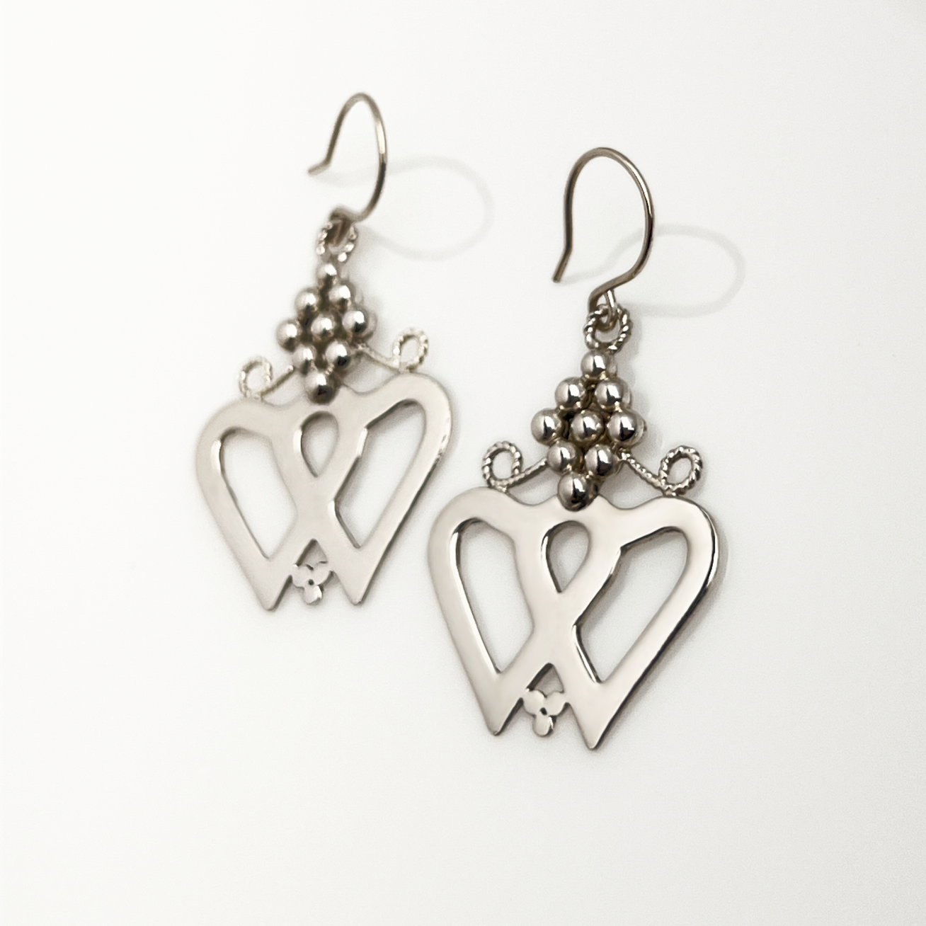 Silver Luckenbooth Earrings dangle from handmade French hooks