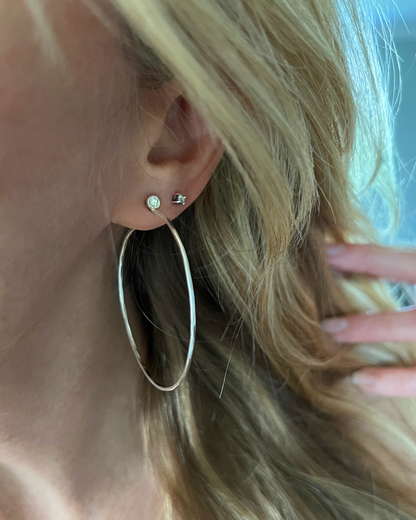 Silver hammered Hoops with White Topaz worn in ear