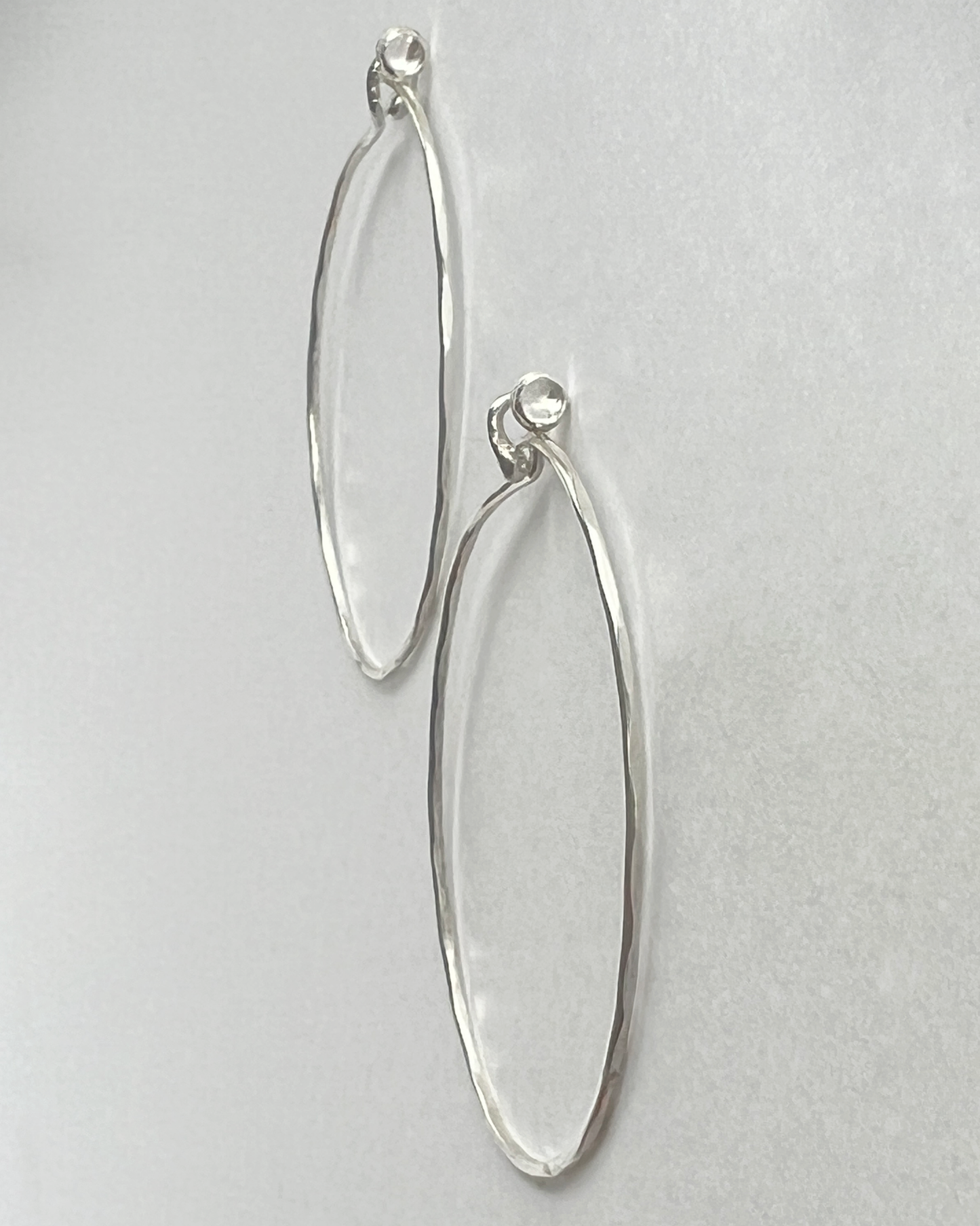 Flatlay profile of Silver hammered Hoops with White Topaz 
