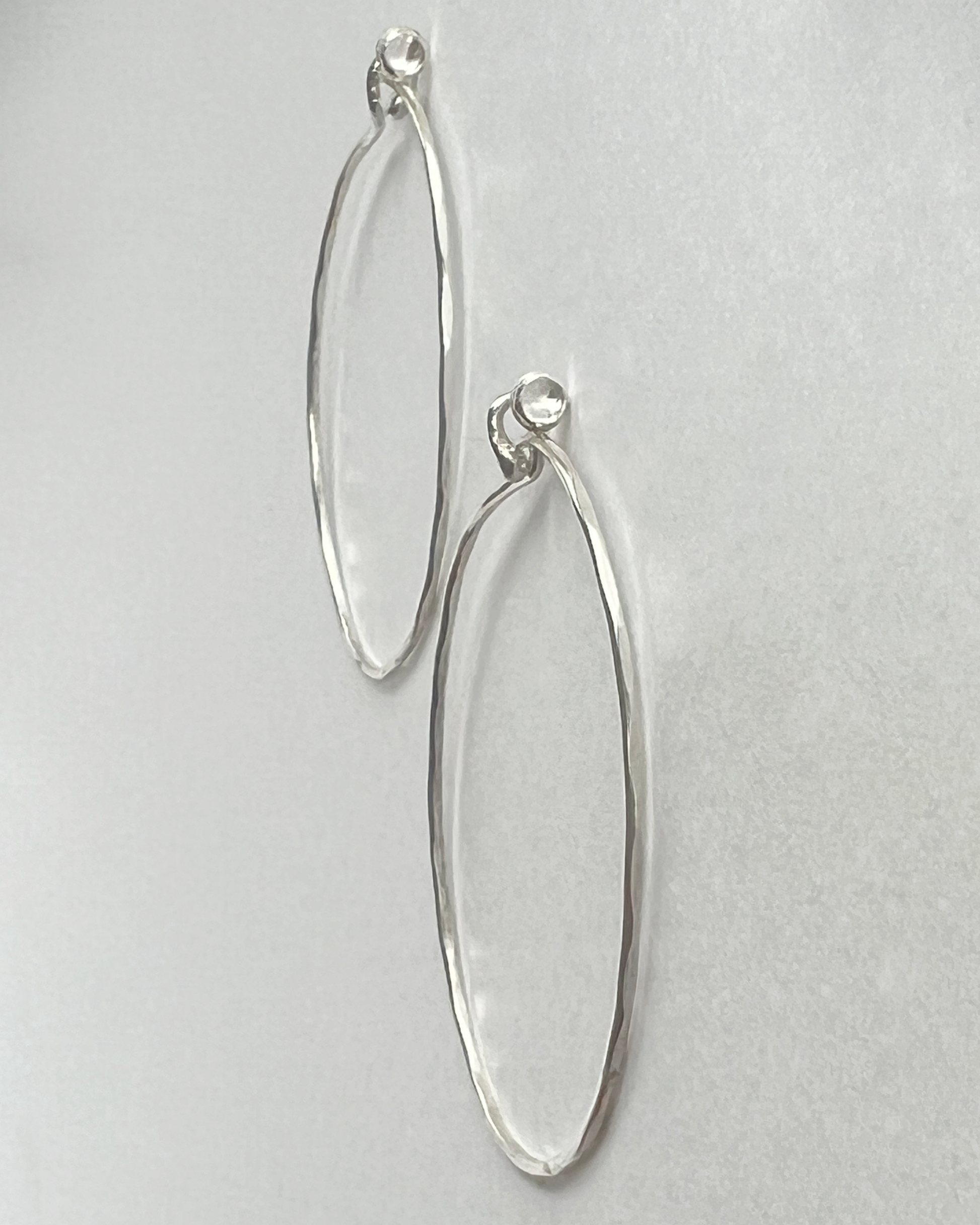 Flatlay profile of Silver hammered Hoops with White Topaz 
